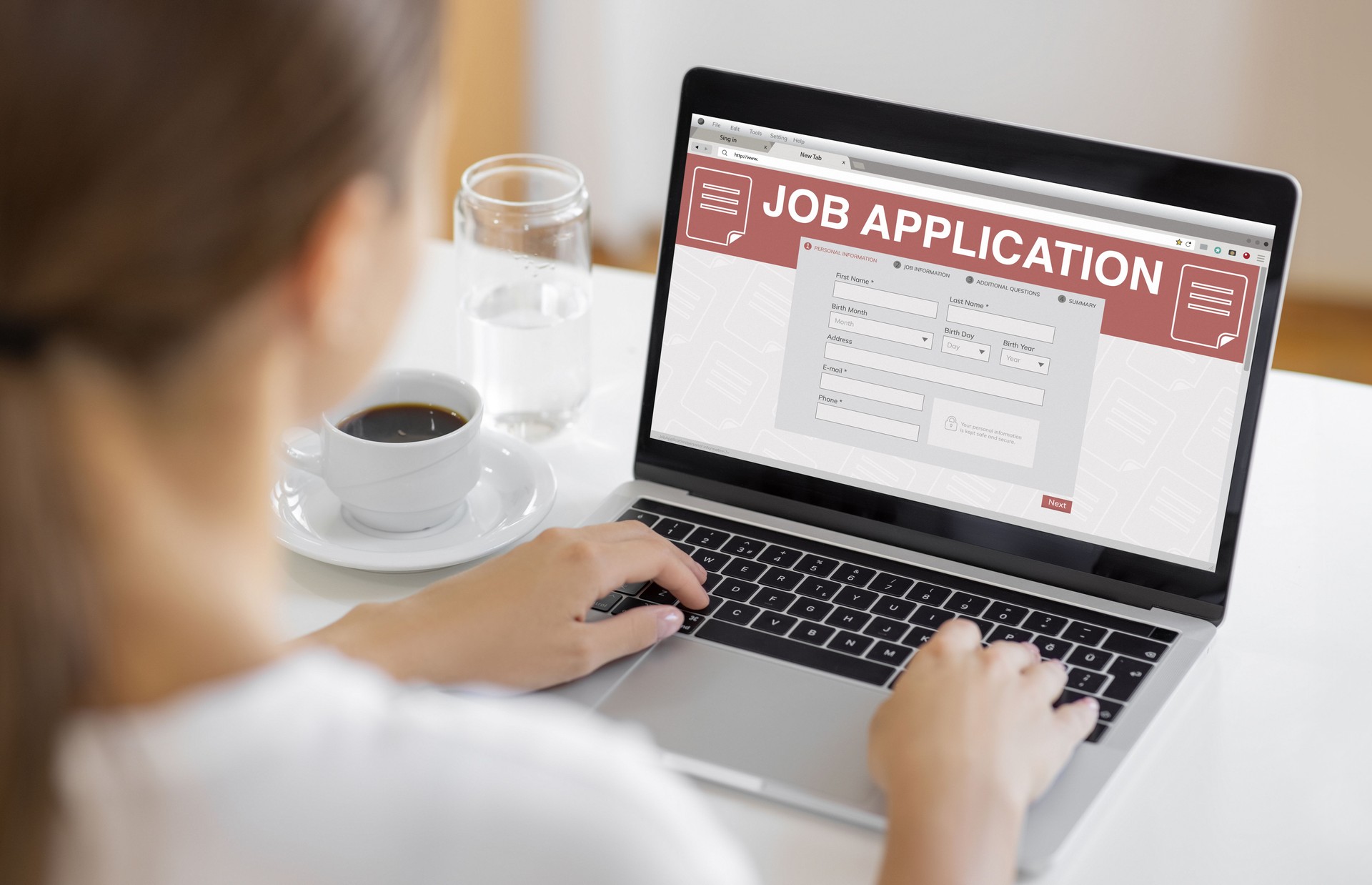 Young Woman Filling Out Online Job Application Form on Laptop